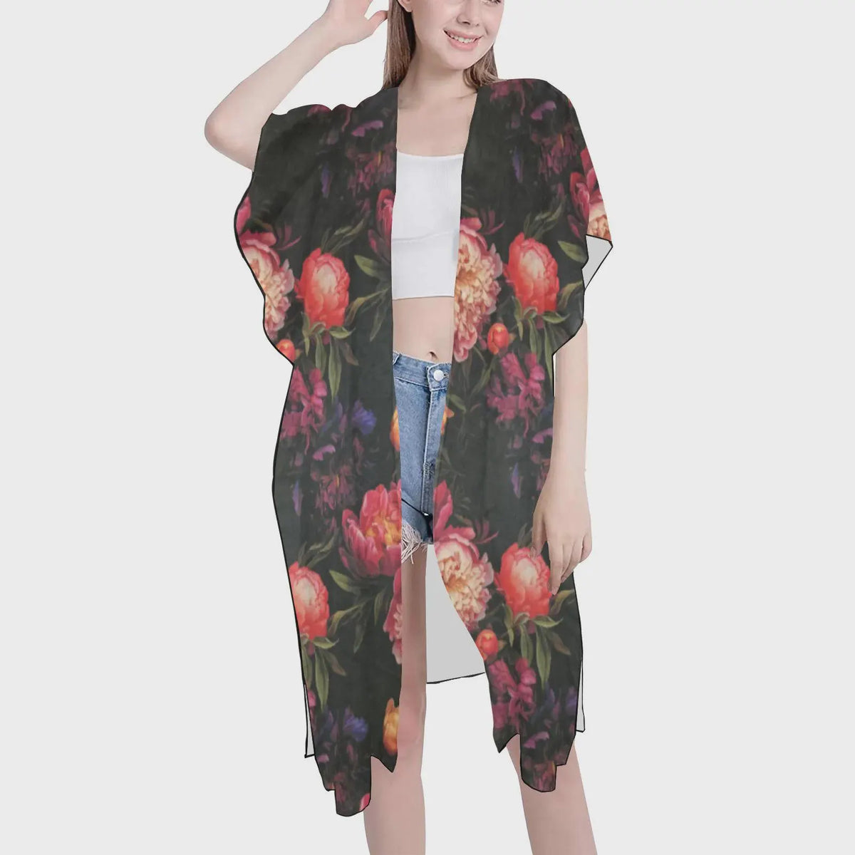 Woman wearing a floral kimono-style garment on a white background