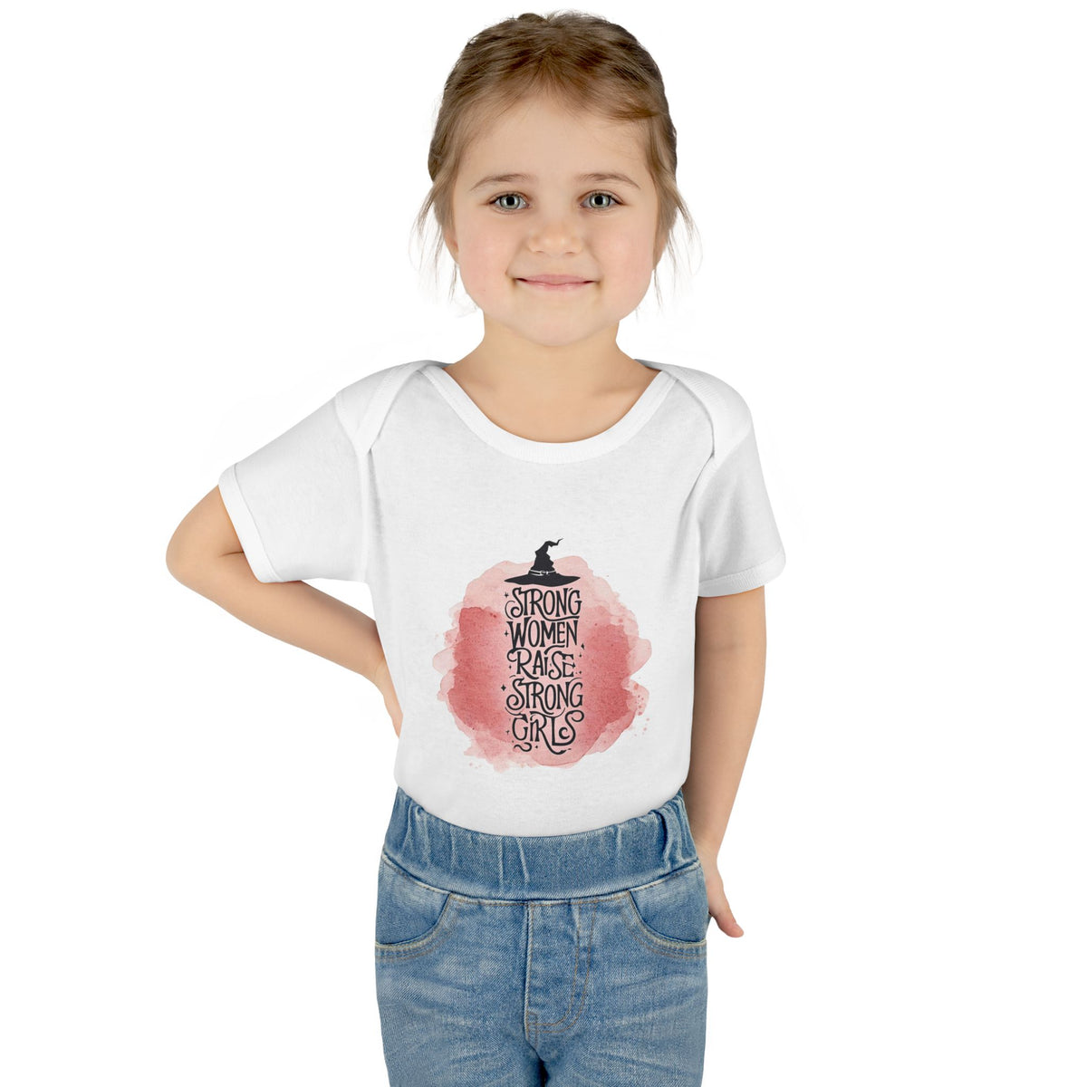 Young girl wearing a white t-shirt with a graphic design and text.