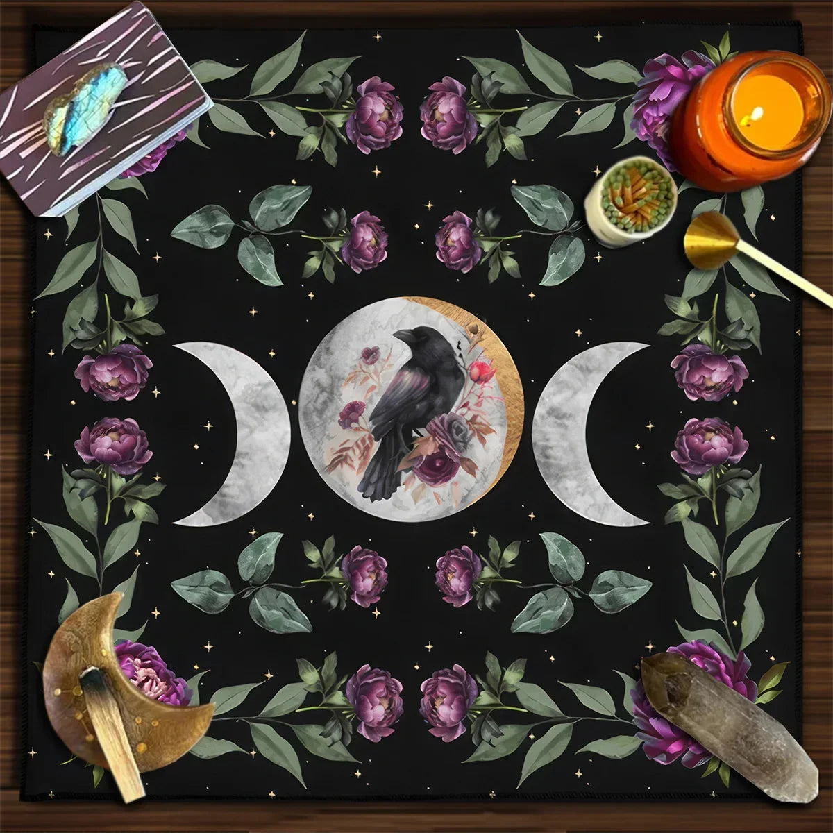 Decorative mat with moon phases, flowers, and a candle on a wooden surface